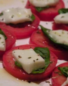 Caprese salad- thinly sliced tomato, with a basil leaf and a chunk of buffalo mozzarella, drizzled with EVOO.